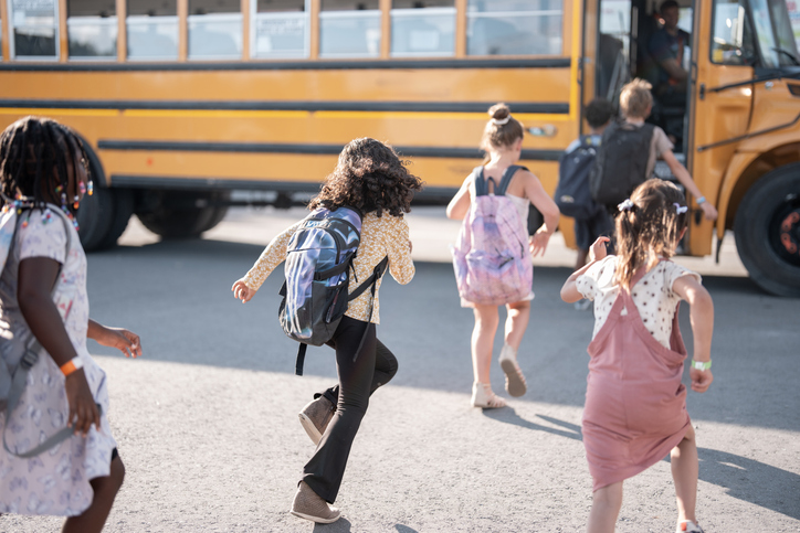 Children Boarding a School Bus on a Sunny Day