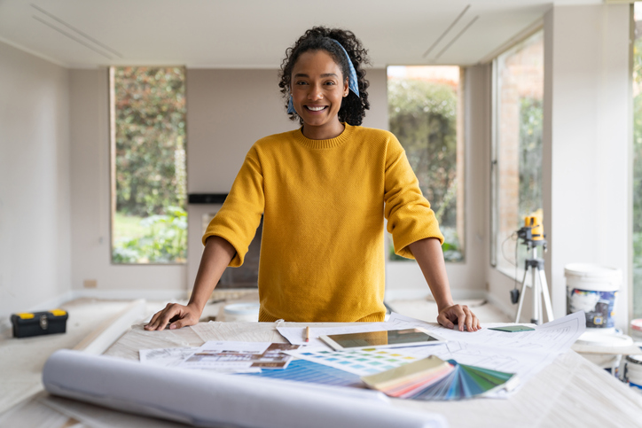 Portrait of a happy interior designer remodeling a house and smiling