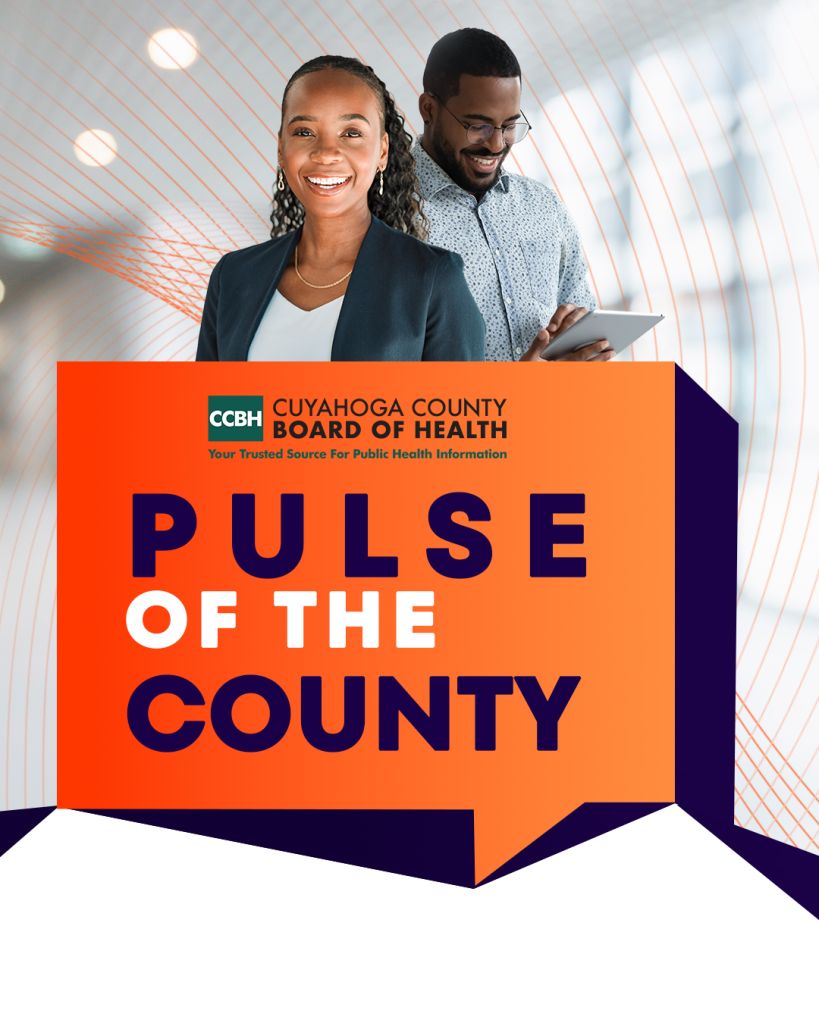 Two people, a smiling woman and a man with glasses, standing in front of a large orange sign that says "PULSE OF THE COUNTY" with the Cuyahoga County Board of Health logo.